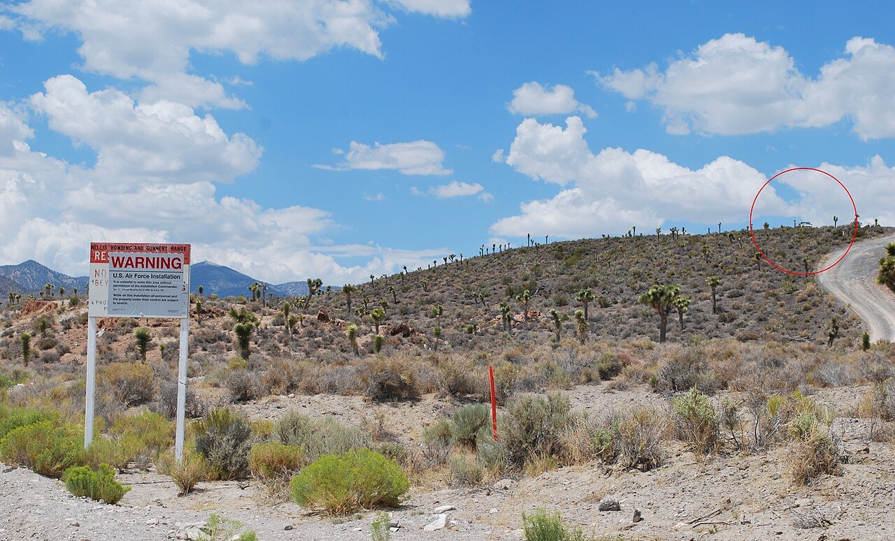 The warning sign and security post at the Groom Lake Road boundary of Area 51, Nevada, the facility the anonymous "Victor" claimed the footage came from. This is a real photograph of the site, not a frame from the video; the interview clip itself is widely assessed as a staged practical-effects hoax.