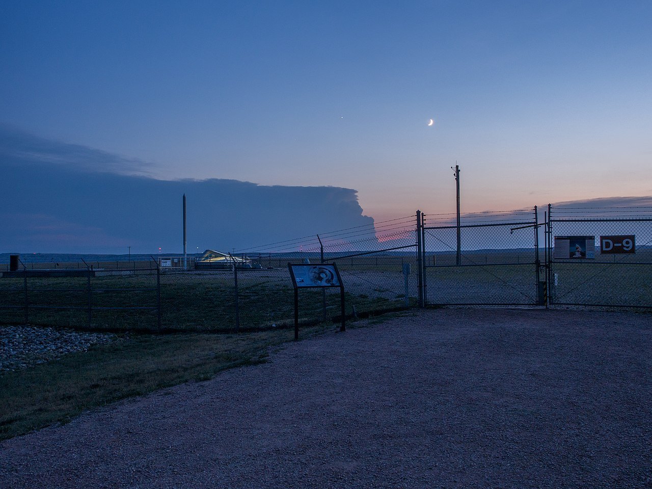 A South Dakota Minuteman missile launch facility (Delta-09) at dusk, the kind of fenced silo the hoax document called Site L-9. The 1977 Ellsworth story exists only in a fabricated typed report; no incident occurred. This is a locator of the missile-field setting.