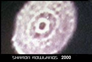 A still frame from Sharon Rowlands' camcorder footage shot over Bonsall, Derbyshire on 5 October 2000, showing the out-of-focus luminous disc with a dark centre. This is a frame from the actual video as circulated, not a recreation or render.