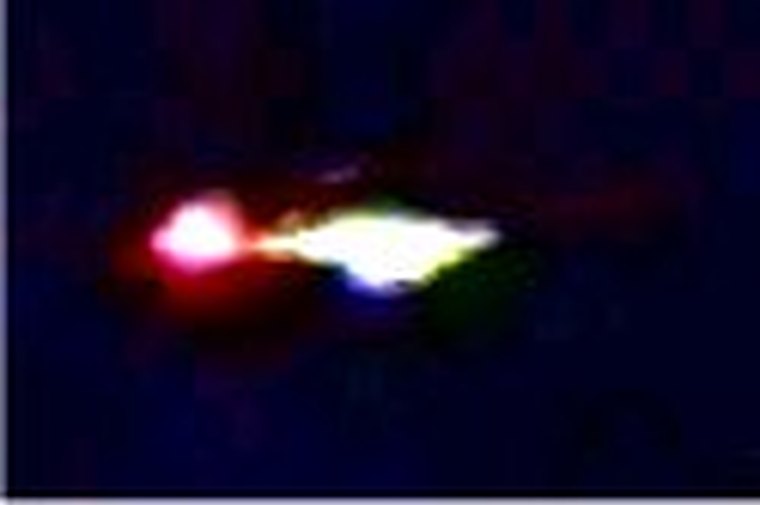 A still from the anonymous "Guardian" videotape mailed to Canadian UFO researchers in October 1991, showing the brightly lit object on the ground beside a red glow. RCMP file 93A-0735 and Department of Transport experts identified the object as most likely a helicopter, with the red glow consistent with the red flares used as ground markers during military night-vision-goggle training. This is a frame from the disputed video, not a verified photograph of a craft.