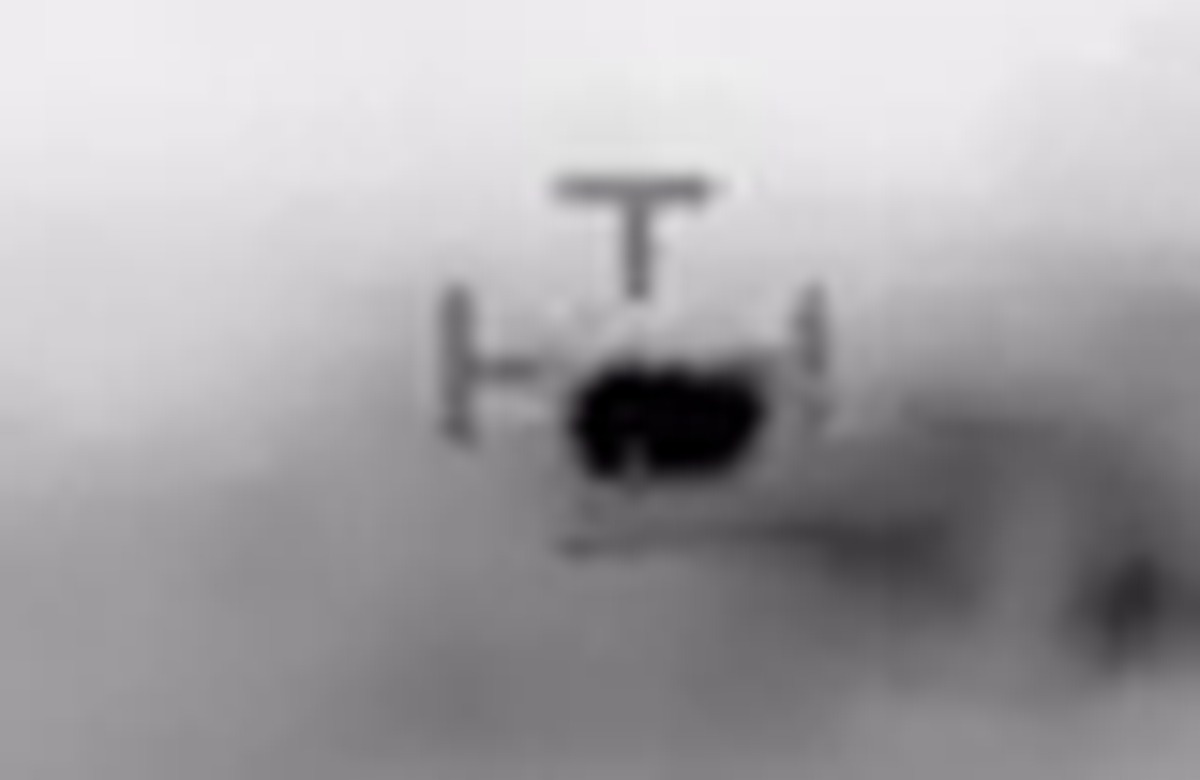 The object enlarged from the frame at 13:58:15, the moment IPACO used for one of its angular measurements. The dark mass shows the paired structure that both sides of the argument describe, read as two thermal spotlights by the Navy crew and as infrared glare from two engine groups by the analysts who identified an airliner. This crop is upscaled from the low resolution circulating copy, so it illustrates the appearance rather than resolving the structure.