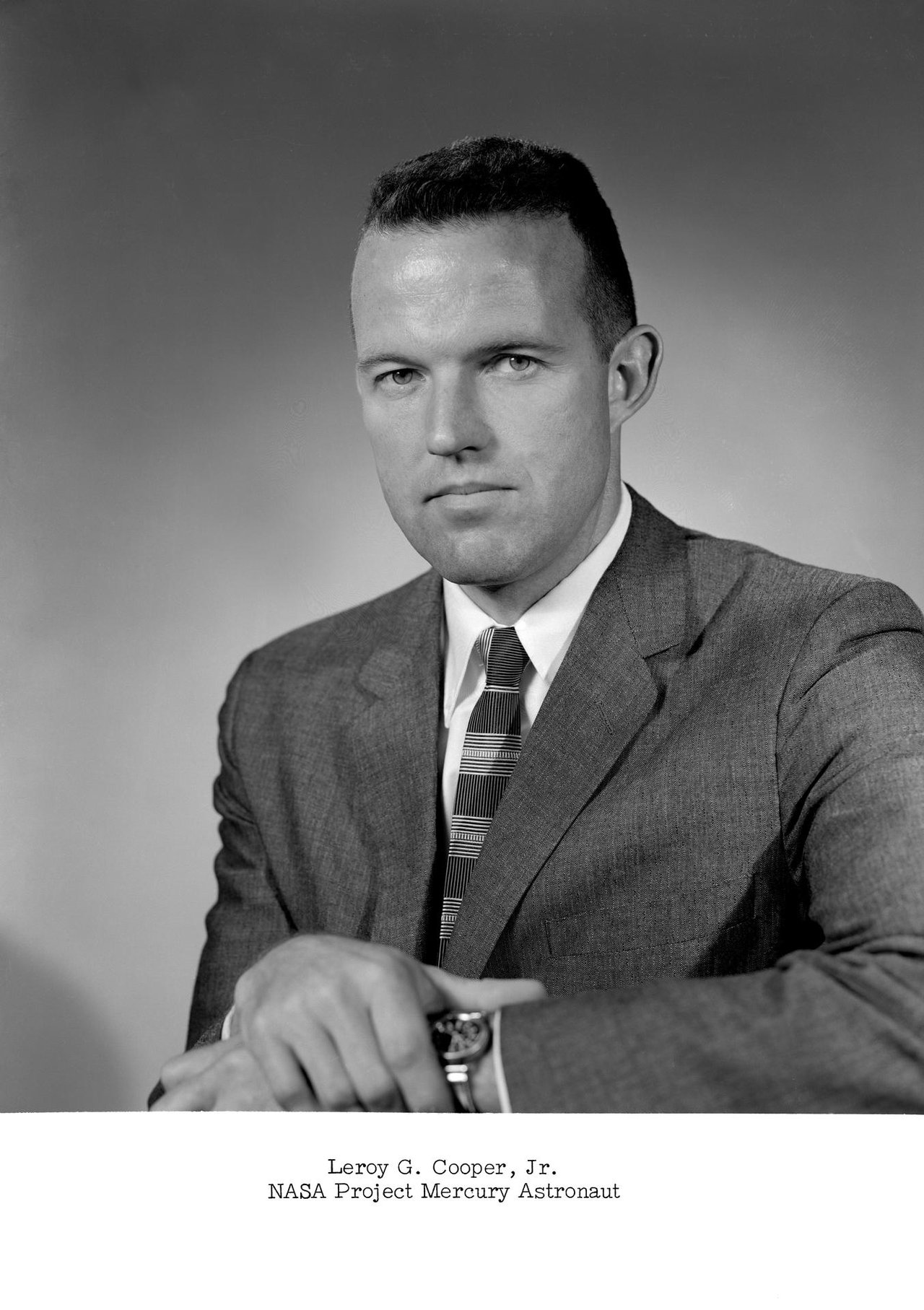 Official NASA portrait of Mercury Seven astronaut and U.S. Air Force test pilot L. Gordon Cooper, taken during the Project Mercury era. This is a real NASA photograph of the man whose claims define the case, not an image of the 1957 object. The actual Edwards object was photographed only as low-resolution 35mm Askania tracking-camera frames, which survive in the Project Blue Book microfilm file (case 4715) at the National Archives in College Park, Maryland.