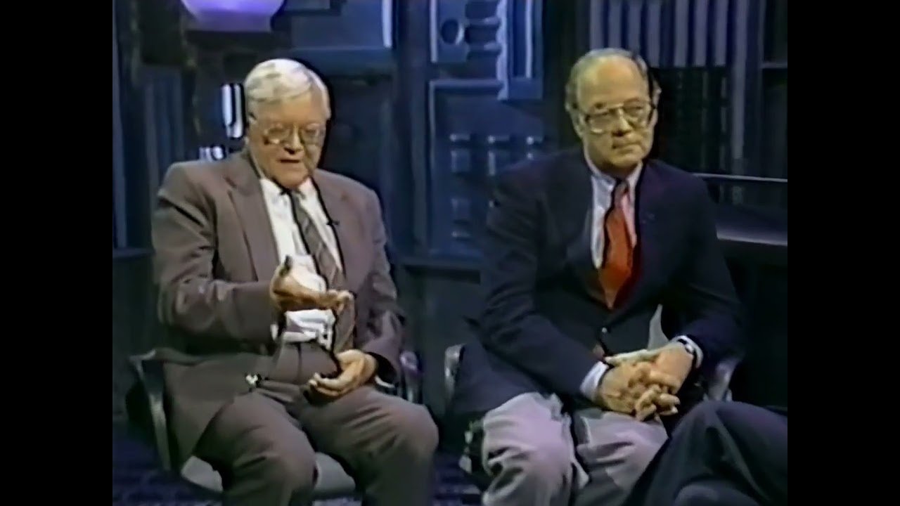 Real frame from the 14 October 1988 national television broadcast in which Robert Emenegger (left) and former Norton AFB audio-visual chief Paul Shartle (right) discussed the Holloman landing film. On this broadcast Shartle stated on the record that he had seen 16mm footage of a disc landing and three beings emerging. This is documentary television footage of the two witnesses making the claim, not a still from the alleged landing film, which has never been produced.