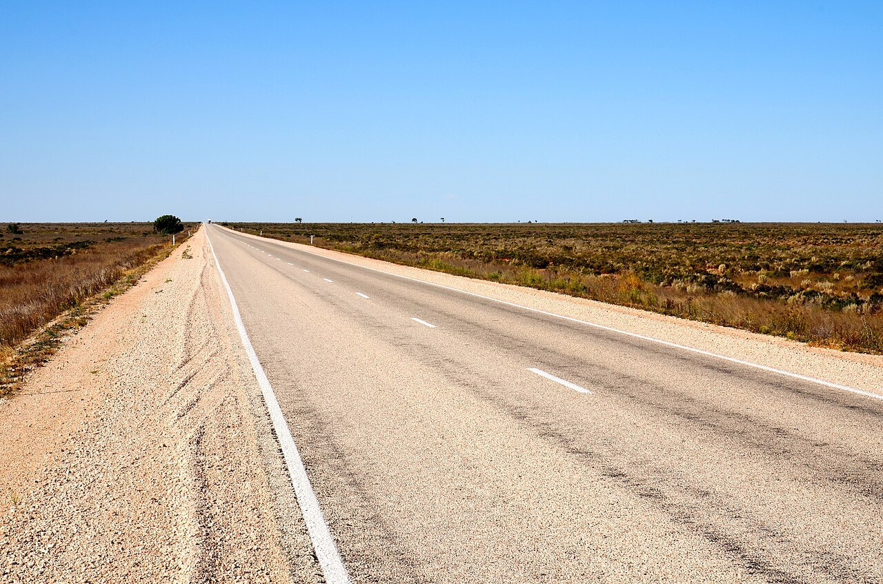 The Eyre Highway crossing the Nullarbor Plain in South Australia, the remote desert road where the Knowles family said a glowing object landed on their car in January 1988. No photograph of the object exists, so this is a locator of the road.