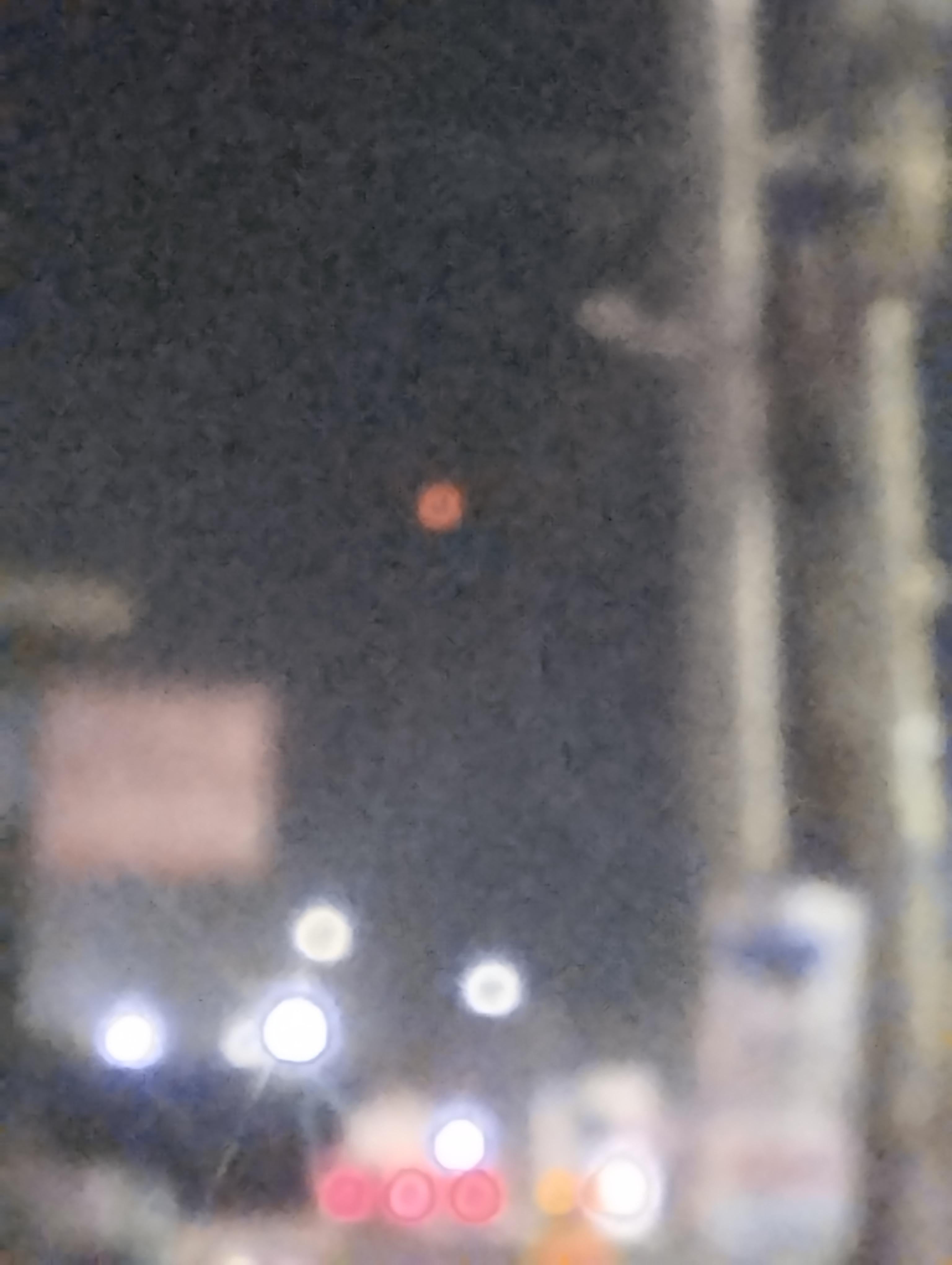 The amber light over Laguindingan Airport, 28 June 2026, high in the frame above the out-of-focus airport and street lighting. Witness photograph.