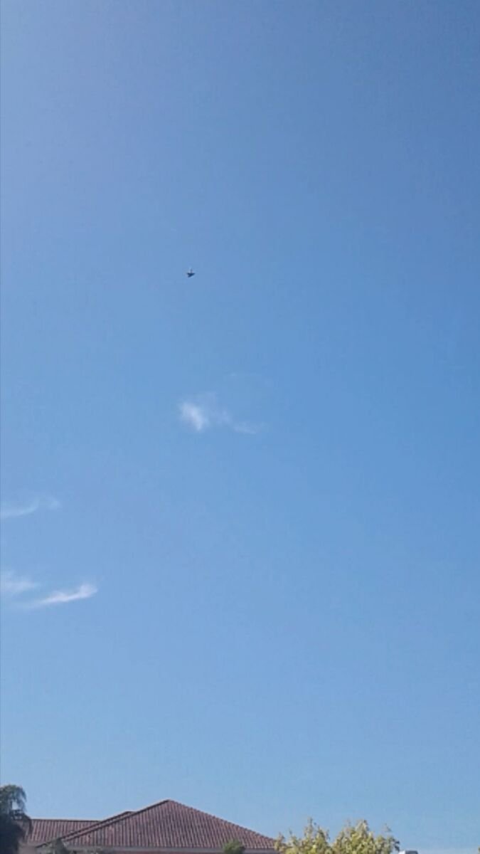 First frame of the 31 August 2017 series: the object as a small dark triangle over the rooftop, before the apparent flare (via Exopolitics).