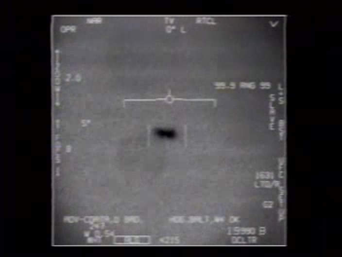 A frame from the official US Navy FLIR1 infrared video of the 14 November 2004 USS Nimitz encounter, showing the dark Tic Tac object held in the ATFLIR targeting reticle. It was recorded by a VFA-41 F/A-18F off Baja California and released by the Pentagon on 27 April 2020.