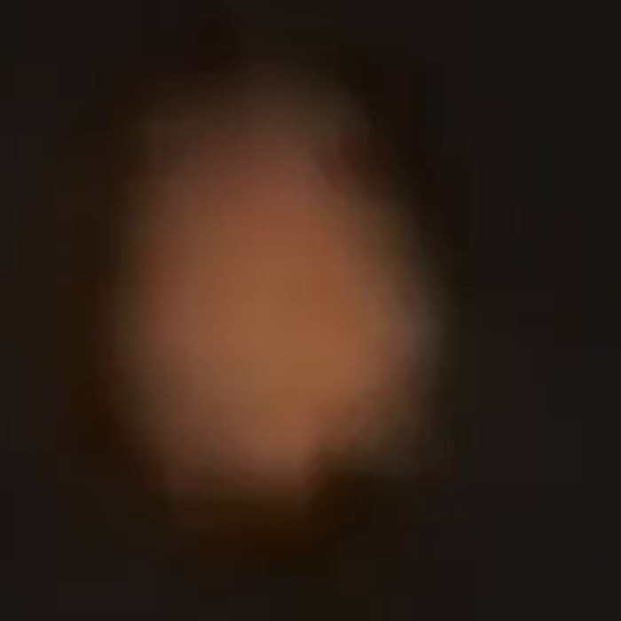 The object at maximum magnification near the end of the recording, showing a rounded orange envelope with a diffuse edge and no structure, navigation lights or strobe. Frame extracted by this archive from the witness's own 62 second video.