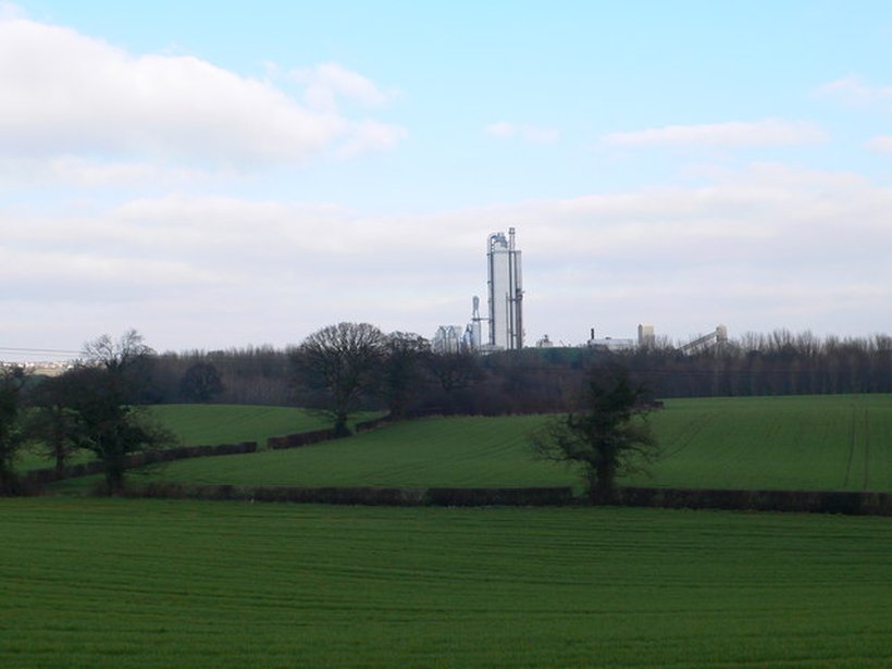 A real present-day photograph of farmland at Padeswood, near Mold, Flintshire, the kind of open field where the 1880s poachers said they saw the purple ball of light. This is a landscape photograph of the actual locality, not an image of the event; no contemporary picture of the sighting exists. The chimney of the Padeswood cement works, a modern structure, stands in the distance.