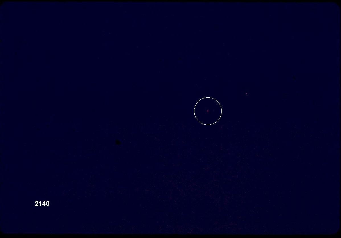 The actual NASA photograph, frame SL3-118-2140, taken by the Skylab 3 crew on 20 September 1973 on magazine CX-35 (Nikon body, 300mm lens, SO-368 Ektachrome). It is one of four exposures of the red object the crew watched for about ten minutes. This is a genuine NASA film frame, not a recreation or render.