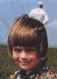 The original 1964 colour photograph taken by Jim Templeton on Burgh Marsh, showing his five-year-old daughter Elizabeth in the foreground with the white "spaceman" figure rising behind her head. This is the actual middle frame of the three he shot, not a recreation or model.