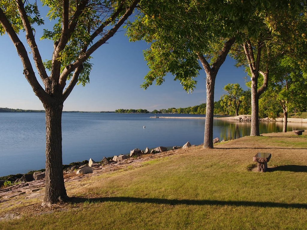 A real photograph of Big Stone Lake seen from Ortonville, Minnesota. This is the spot on the Minnesota to South Dakota border where Marlen Hewitt and three hunting newspapermen, Lem Kaercher of the Ortonville Independent and Don and Dick Olson of the Marshall Messenger, jointly watched the color-changing object hover in the clouds to the southwest in November 1956. This is a present-day landscape photograph of the location, not an image of the object.