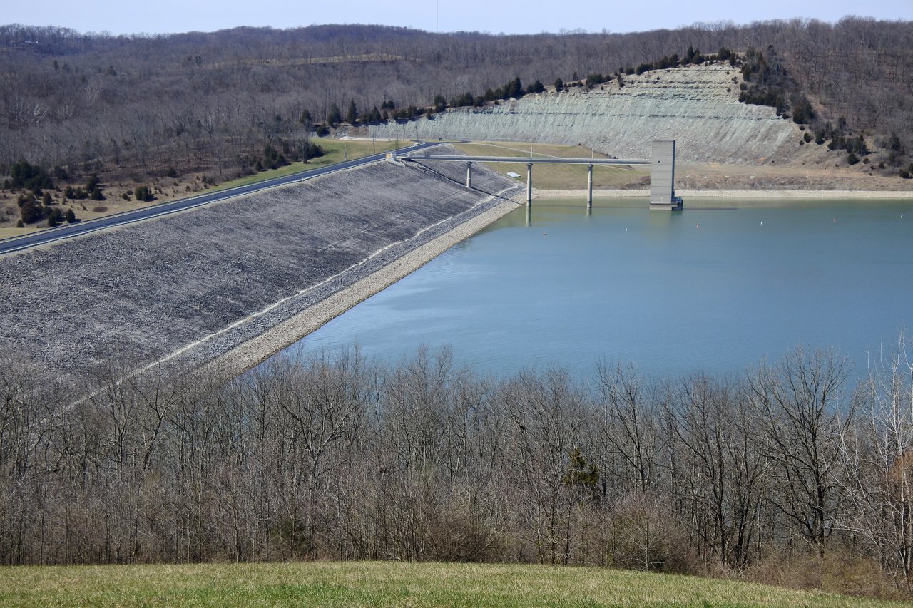 A real photograph of Brookville Lake Dam in southeastern Indiana, the reservoir whose campground the Franklin County EMS technician was patrolling when he reported a silent, treetop-level object with three red triangular lights on the night of 9 August 2002. This is a daytime location photograph, not an image of the object; no photograph of the reported object exists.