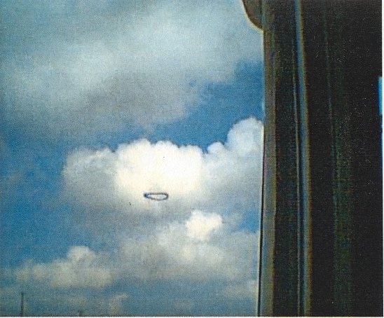 Photo 1 of 7 in the original sequence: the dark, well-defined ring photographed by the truck driver through his cab window over the Beck Street corridor in north Salt Lake City on 1 March 2001. This is the witness's own digital photograph, not a recreation.
