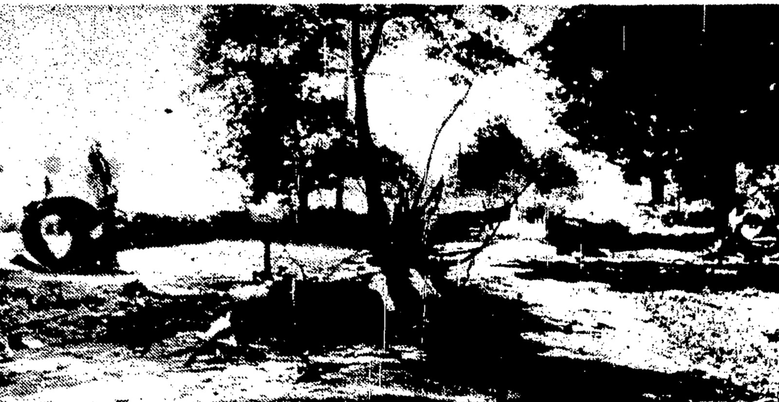 The wreckage of F-94C Starfire 51-13559 at the Walesville intersection, photographed the day of the crash and printed the following morning. The Post-Standard caption places the aircraft's centre section at the left, the engine lying on the highway, and the tail still smouldering at the right, about 400 feet from the junction where the falling aeroplane struck a passing car and killed its three occupants. Debris was scattered over a 500 yard area. This is the crash site itself, not the balloon that drifted over Utica that evening and that later writers merged into the story.