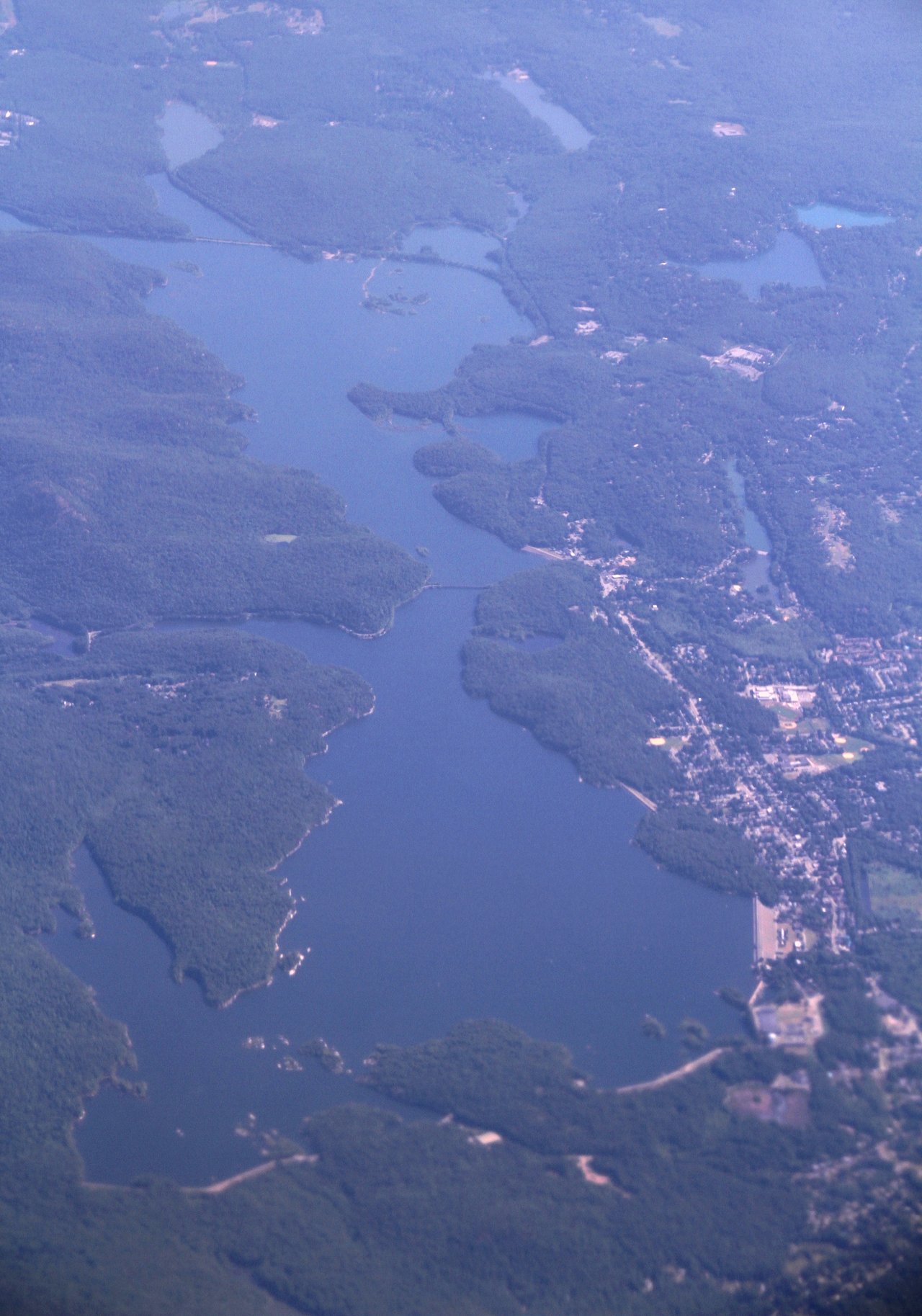 A present-day photograph of the Wanaque Reservoir in Passaic County, New Jersey, the body of water over which the January 1966 mass sighting and ice-hole reports were centered. This is a real photograph of the actual location, not an image of the reported object. The famous "beam" photographs associated with the case are deliberately not used here, because independent photo analysis has shown that series to be a fabrication.