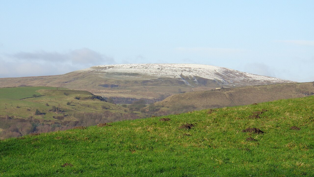 Brown Wardle Hill above the village of Wardle on the Pennine Moors near Rochdale, the moorland where nineteen-year-old Gwynneth Fitton reported a domed object moving between the hills on a frosty February night in 1957. No photograph of the object exists.