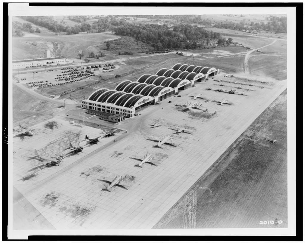 Real US Air Force aerial photograph of the Area B hangar line at Wright Field / Wright-Patterson Air Force Base, Dayton, Ohio, taken between 1940 and 1950. These barrel-vaulted hangars and the labs behind them are the physical setting of the "Wright Field 1947" recovery claims. The photo is documentary; it shows the base, not any craft or bodies, none of which were ever photographed or recovered on the record.
